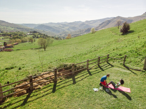 drone view of Multiracial couple training together in mountains
