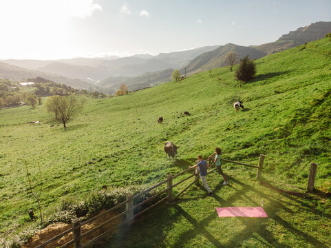 drone view of Multiracial couple training together in mountains
