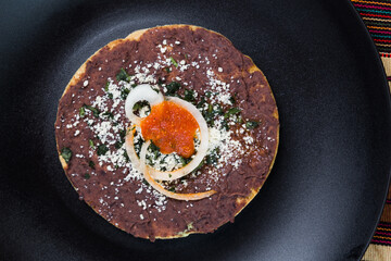 top view of a black bean tostada from Guatemala