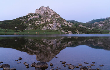 Symmetrical Mountain Reflected In A Lake  