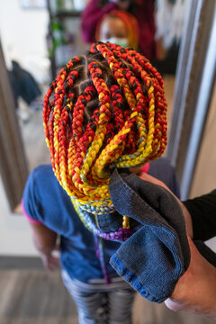 Stylist dries ends of synthetic box braids