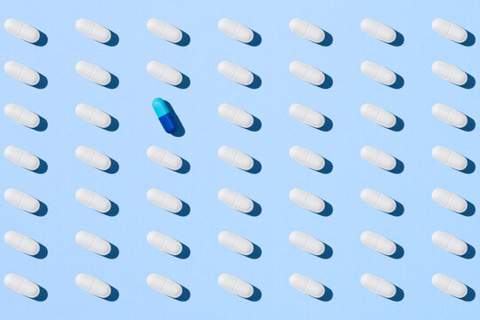 Blue pill capsule and white pills
