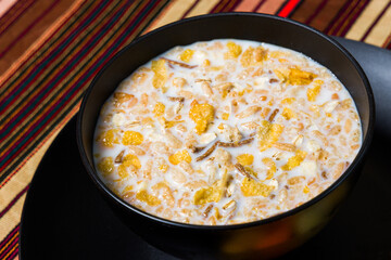 Fiber cereal served with milk in a black bowl