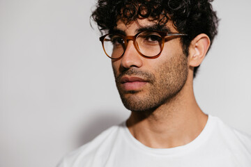 Serious Hispanic man in glasses