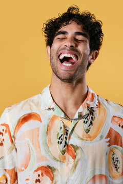 Excited Hispanic man laughing loudly
