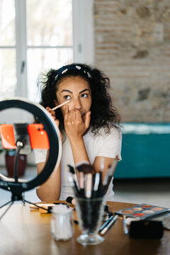 Beauty blogger applying makeup on eyes