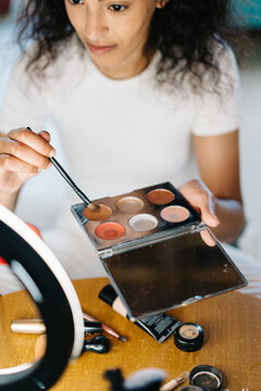 Woman with cosmetic products and accessories