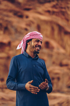 Arabic man smiling in the desert.