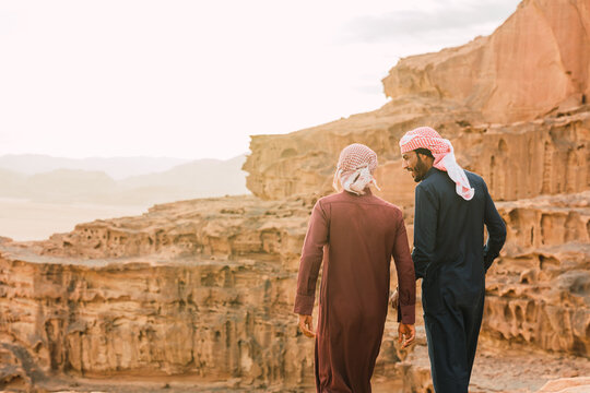 Arabic men talking near mountains