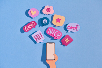 Hands hold mobile phone with different messages.