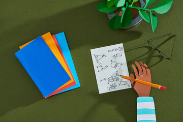 Mathematics book written by hand with arithmetic problems and books