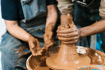 Unrecognizable potters' hands at work
