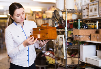 Young woman is buying medicine chest in the store.