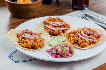 Mexican tacos with cochinita pibil, onion and lemon, traditional mexican food in Mexico City