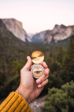 Unrecognizable person holding a compass in the mountains