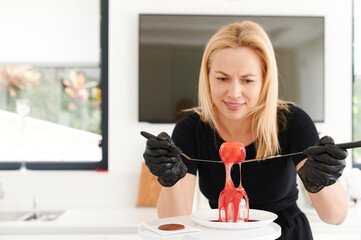 Woman making a decadent dessert in her kitchen