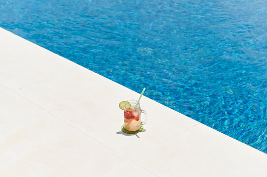 Cocktail sitting at the edge of a pool