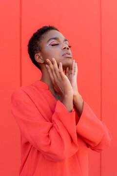 Trendy black woman touching face