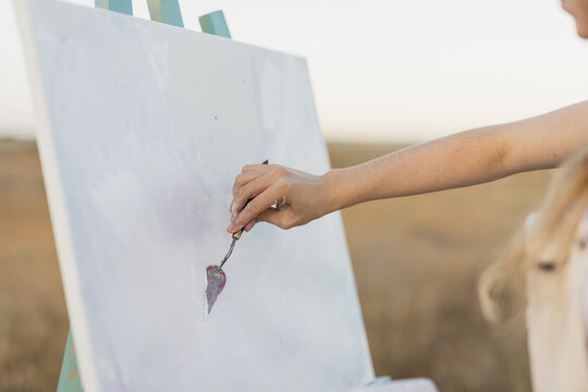 woman artist with spatula in hand