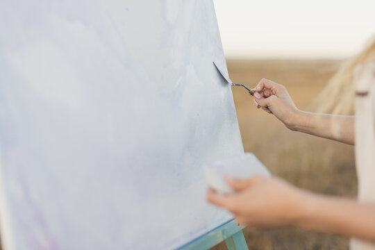 woman artist with spatula in hand