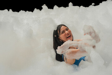 Girl fun happy in foam pool outdoor party in summer