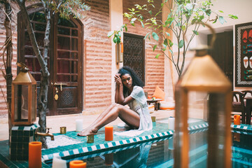 Woman sitting in a bikini at the swimming pool