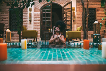 Multiracial couple relaxing in a swimming pool