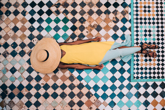 Woman lying down in a geometric mosaic floor