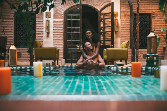 Multiracial couple relaxing in a swimming pool