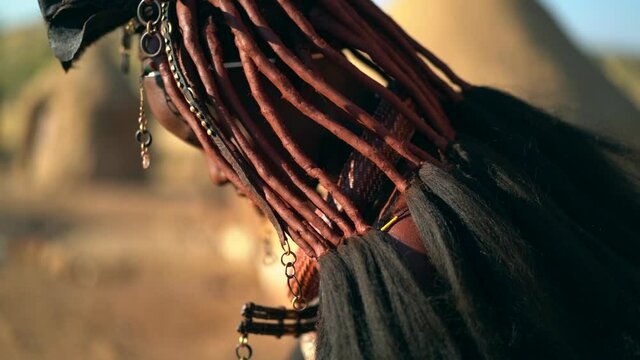 Young Himba woman in traditional Himba village near Kamanjab in northern Namibia, Africa, slow motion shot.  