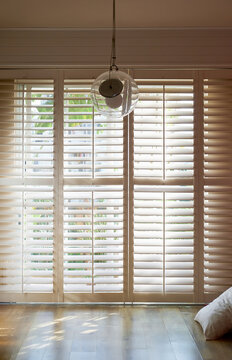 Closeup of wooden shutters of the balcony under the sunset light