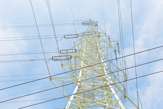 Power tower wires intersect in the blue sky