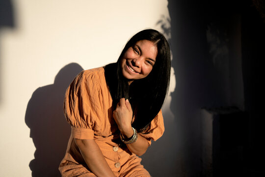 Young brunette woman smiling with fashion dress at home