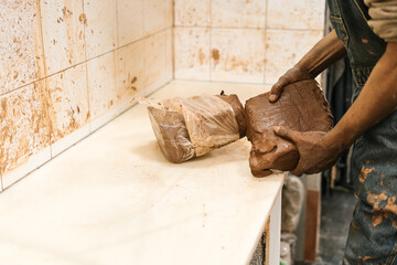 Artisan with bulk clay in his hand