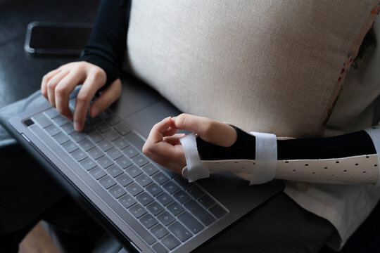 A woman sitting on a sofa using a mobile phone