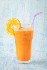carrot and orange fresh juice on blue table