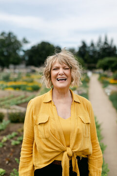 Beautiful, Blond Senior Woman Laughing in Garden