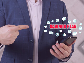  SAVINGS PLAN text in search bar. Modern Banker looking at cellphone. An employer-provided...