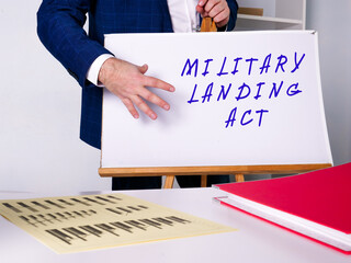 Business concept meaning MILITARY LANDING ACT with inscription on the sheet.