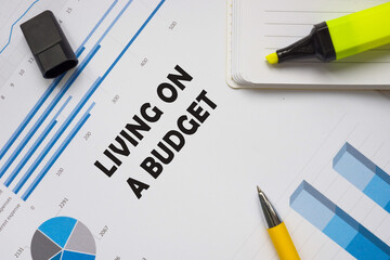 Financial concept about LIVING ON A BUDGET with phrase on the page.
