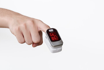 Focus at Pulse oximeter on index finger of young man hand on isolated white background, Measurement of blood oxygen and pulse
