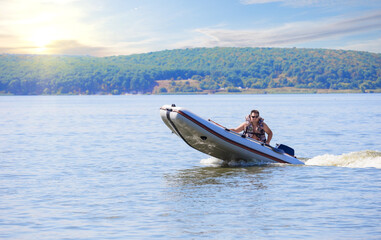 A rubber motor boat running along the water in beautiful sunny day