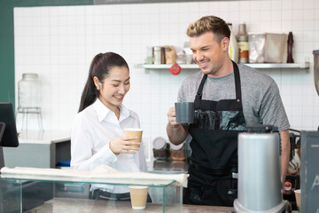 barista and owner tasting a cup of coffee before opening in coffee shop