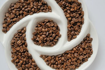Coffee beans in textured  plate. Roasted coffee beans.Arabica coffee. Morning traditional  drink. Coffee beans texture
