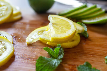 Sliced fresh lemons and lime. Wooden table.