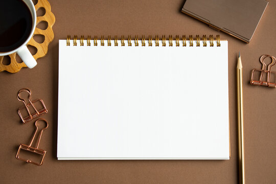 Brown background and blank notebook mock-up, office production