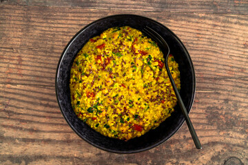 vegan golden savoury oats with bell pepper chickpeas and spinach topped with fla seeds, healthy plant-based food