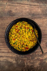vegan golden savoury oats with bell pepper chickpeas and spinach topped with fla seeds, healthy plant-based food