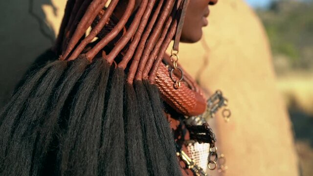 Young Himba woman in traditional Himba village near Kamanjab in northern Namibia, Africa, slow motion shot.  
