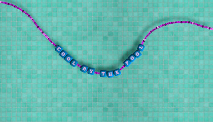 Summer concept. A beaded necklace with alphabet beads that read the phrase 